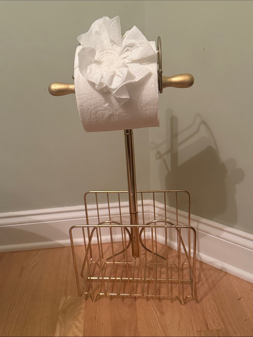 1970s Hollywood Regency brass towel caddy with magazine holder below.